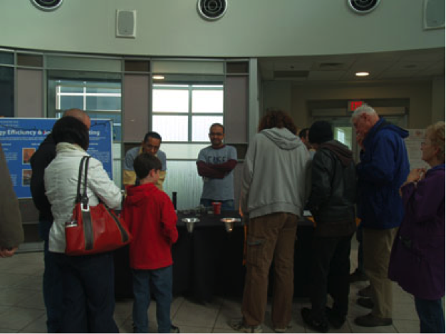 Visitors look at information at CNSE Community Day 