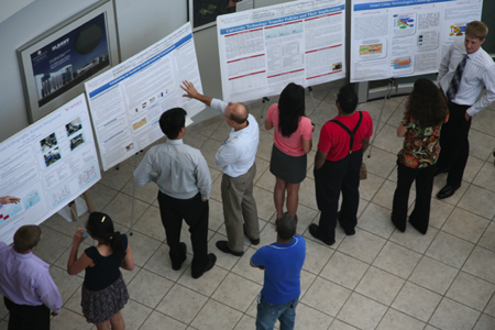 Faculty and student view posters at the poster presentation
